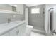 Modern bathroom featuring sleek gray tile, updated fixtures and a walk-in shower at 1691 Lakeview Pl, Englewood, FL 34223