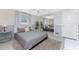 Relaxing bedroom featuring natural light, a ceiling fan, and a mirrored closet at 1691 Lakeview Pl, Englewood, FL 34223