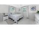 Inviting bedroom features coastal decor, comfy bedding, and ample natural light for a serene retreat at 1691 Lakeview Pl, Englewood, FL 34223