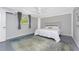 A bright bedroom features a ceiling fan, window, gray walls, and white linens at 1691 Lakeview Pl, Englewood, FL 34223
