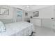 Bright bedroom features a coastal theme, comfortable bed, and plenty of natural light at 1691 Lakeview Pl, Englewood, FL 34223