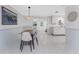 Bright dining area features stylish table, modern lighting, and convenient access to the kitchen and outdoor views at 1691 Lakeview Pl, Englewood, FL 34223