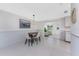An open-concept dining area connects to the kitchen and bright living space at 1691 Lakeview Pl, Englewood, FL 34223