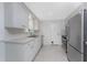 The kitchen features white cabinetry, stainless appliances, and access to an outdoor area at 1691 Lakeview Pl, Englewood, FL 34223