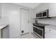 This kitchen features bright lighting and modern stainless steel appliances at 1691 Lakeview Pl, Englewood, FL 34223