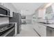 Well-lit kitchen featuring stainless steel appliances and crisp white cabinets at 1691 Lakeview Pl, Englewood, FL 34223