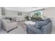 Spacious living room featuring stylish seating, a cozy rug, and elegant decor at 1691 Lakeview Pl, Englewood, FL 34223