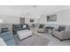 Comfortable living area with sofas, a ceiling fan, and a view into the dining area at 1691 Lakeview Pl, Englewood, FL 34223