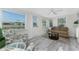 Comfortable sunroom offers backyard pond views, and casual seating at 1691 Lakeview Pl, Englewood, FL 34223