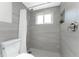 Walk-in shower featuring modern tile and a convenient shower niche at 1691 Lakeview Pl, Englewood, FL 34223