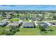 Scenic aerial view of a peaceful neighborhood with houses nestled among trees and winding canals at 171 Mark Twain Ln, Rotonda West, FL 33947