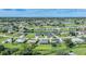 Picturesque aerial view of a residential area featuring homes surrounded by lakes and verdant landscapes at 171 Mark Twain Ln, Rotonda West, FL 33947
