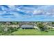 Aerial shot showcasing a charming home with a large yard in a serene residential community at 171 Mark Twain Ln, Rotonda West, FL 33947