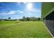 Spacious backyard with lush green grass and surrounding trees, offering privacy and tranquility at 171 Mark Twain Ln, Rotonda West, FL 33947