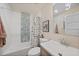 Well-lit bathroom showcases a shower/tub, sleek vanity, toilet, and stylish fixtures at 171 Mark Twain Ln, Rotonda West, FL 33947