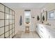Bright bathroom includes double sinks, white cabinetry and expansive glass shower at 171 Mark Twain Ln, Rotonda West, FL 33947