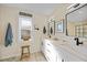 Bathroom includes double sinks, white cabinetry and expansive glass shower at 171 Mark Twain Ln, Rotonda West, FL 33947