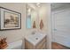 Modern bathroom featuring a stylish vanity with sleek sink, bright mirror, and contemporary lighting at 171 Mark Twain Ln, Rotonda West, FL 33947