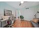 Bedroom features hardwood floors, ceiling fan, a workstation and closet at 171 Mark Twain Ln, Rotonda West, FL 33947