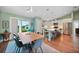 Open dining area with modern light fixture, sleek furniture, and kitchen view, perfect for Gathering meals and entertaining at 171 Mark Twain Ln, Rotonda West, FL 33947