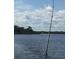 Relaxing fishing scene on calm waters with a lush shoreline visible in the background at 171 Mark Twain Ln, Rotonda West, FL 33947