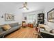 Bright home office featuring hardwood floors, a modern desk, and a comfortable seating area at 171 Mark Twain Ln, Rotonda West, FL 33947
