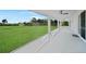 Spacious lanai offering a tranquil view of the lush green backyard, perfect for outdoor living at 171 Mark Twain Ln, Rotonda West, FL 33947