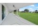 Expansive lanai with ceiling fans, offering a seamless transition to the lush backyard at 171 Mark Twain Ln, Rotonda West, FL 33947