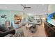 Open-concept living room with kitchen view, featuring sleek furnishings, contemporary decor, and plenty of natural light at 171 Mark Twain Ln, Rotonda West, FL 33947