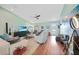 Comfortable living room with hardwood floors, ceiling fan and stylish decor, creating a welcoming space for relaxing and socializing at 171 Mark Twain Ln, Rotonda West, FL 33947
