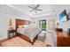 Bright main bedroom with wood accents, ceiling fan, and sliding door access to outdoor space at 171 Mark Twain Ln, Rotonda West, FL 33947