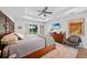 Sunny main bedroom with wood accents, ceiling fan, and slider to patio at 171 Mark Twain Ln, Rotonda West, FL 33947