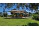 A vibrant playground with slides and climbing structures, set amidst a backdrop of lush greenery and shade canopies at 171 Mark Twain Ln, Rotonda West, FL 33947