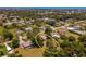 Aerial view of a home in a lush neighborhood with surrounding trees and other residential properties at 1712 Fessler St, Englewood, FL 34223