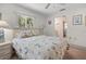 Inviting bedroom featuring soft lighting, a comfortable bed, and a view to an adjacent bathroom at 1712 Fessler St, Englewood, FL 34223