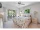 Comfortable bedroom featuring a ceiling fan, sliding glass doors to the exterior, and coordinating furnishings at 1712 Fessler St, Englewood, FL 34223