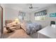 Cozy bedroom featuring carpet flooring, ceiling fan, and windows with patterned valances at 1712 Fessler St, Englewood, FL 34223