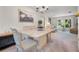 Open-concept dining area featuring a marble table, soft carpet, and views into the adjacent living space at 1712 Fessler St, Englewood, FL 34223