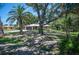Charming home nestled amongst palm and oak trees on a sunny day at 1712 Fessler St, Englewood, FL 34223