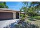 Lovely home with an attached garage and a landscaped front yard at 1712 Fessler St, Englewood, FL 34223