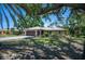 Beautiful single-story home with lush landscaping and mature trees at 1712 Fessler St, Englewood, FL 34223