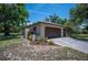 A spacious two-car garage with manicured landscaping at 1712 Fessler St, Englewood, FL 34223