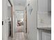 Hallway view showcasing neutral colors and tile flooring, leading to bedrooms and laundry area at 1712 Fessler St, Englewood, FL 34223