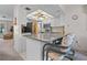 Kitchen with granite countertops, stainless steel appliances, and an island with barstool seating at 1712 Fessler St, Englewood, FL 34223