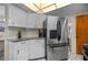 Kitchen featuring a stainless steel refrigerator and white cabinetry with granite countertops at 1712 Fessler St, Englewood, FL 34223