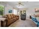 Inviting living room featuring plush seating, a ceiling fan, and sliding glass doors to an outdoor space at 1712 Fessler St, Englewood, FL 34223