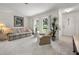 Cozy living room with large windows, plush carpet, and comfortable seating, perfect for relaxation at 1712 Fessler St, Englewood, FL 34223