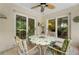 Relaxing screened-in porch with tile flooring showing the outdoor living space for dining at 1712 Fessler St, Englewood, FL 34223