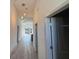 Hallway view with stylish pendant lighting and modern finishes at 18043 Hillsborough Blvd, Port Charlotte, FL 33954