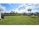 Expansive backyard with waterfront access and lush green lawn, perfect for outdoor activities at 19 Oakwood Dr N # 19, Englewood, FL 34223